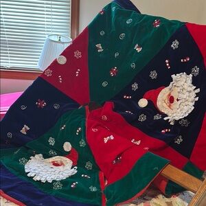 52 “ circle Christmas tree skirt. Very colorful with Santa faces